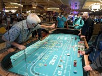 LAS VEGAS, NEVADA - JUNE 04: Guests play craps on a table with plexiglass safety shields at Bellagio Resort & Casino on the Las Vegas Strip after the property opened for the first time since being closed on March 17 because of the coronavirus (COVID-19) pandemic on June 4, 2020 …