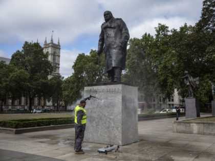 LONDON, ENGLAND - JUNE 08: A worker cleans the Churchill statue in Parliament Square that had been spray painted with the words 'was a racist' on June 08, 2020 in London, England. Outside the Houses of Parliament, the statue of former Prime Minister Winston Churchill was spray-painted with the words …