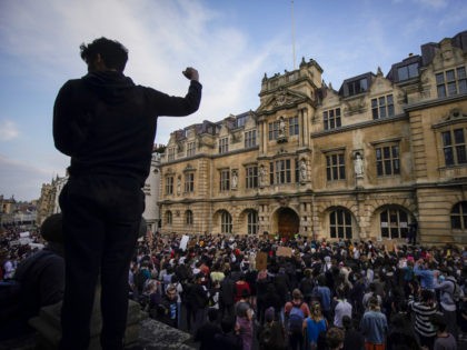 OXFORD, ENGLAND - JUNE 09: Demonstrators gather outside University of Oxford's Oriel College during a protest called by the Rhodes Must Fall campaign on June 09, 2020 in Oxford, England. The Rhodes Must Fall campaign protests outside University of Oxford's Oriel College where a statue of imperialist Cecil John Rhodes …