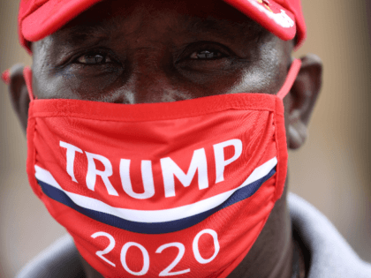 A supporter of U.S. President Donald Trump wears a campaign hat and mask ahead of a rally at the BOK Center, June 20, 2020 in Tulsa, Oklahoma. Trump is scheduled to hold his first political rally since the start of the coronavirus pandemic at the BOK Center on Saturday while …