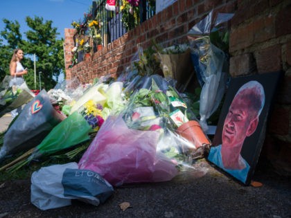 WOKINGHAM, ENGLAND - JUNE 22: A painted portrait is seen among the flowers as students pay their respects to the murdered school teacher James Furlong outside The Holt School, on June 22, 2020 in Wokingham, England. Khairi Saadallah, a 25-year-old refugee from Libya, was arrested on Saturday evening suspected of …
