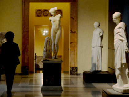 A picture taken on January 26, 2016 shows a visitor walking past an ancient Roman marble statue at Rome's Capitoline Museum (Musei Capitolini) on Capitol Hill. Italy's desire to court visiting Iranian President Hassan Rouhani extended to covering up classical nude sculptures in the Capitoline Museum, where he met Prime …