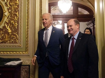 US Vice President Joe Biden walks out of the Senate chamber with US Democratic Senator from Delaware Chris Coons after attending a bipartisan tribute honoring Biden's service as a member of the Senate and as vice president, at the Capitol in Washington, DC, on December 7, 2016. / AFP / …