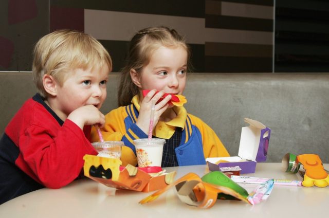 MELBOURNE, AUSTRALIA - AUGUST 29: Children eat a new Happy Meal at the McDonald's re