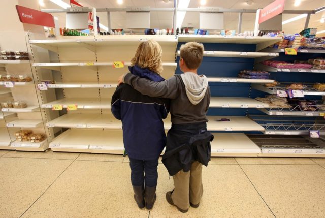 TEWKESBURY, UNITED KINGDOM - JULY 23: A mother and her son look at the empty bakery shelves in a supermarket on July 23 2007 in Tewkesbury, England. Flooding has caused wideswept disruption across the country with further regions braced for more floods. (Photo by Matt Cardy/Getty Images)