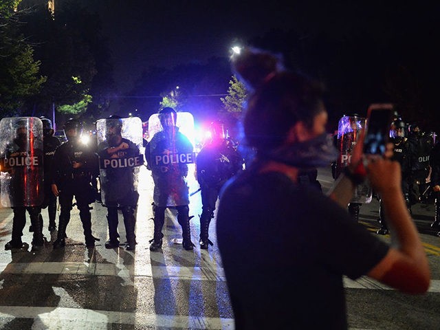 ST. LOUIS, MO - SEPTEMBER 15: Law enforcement officers stand guard during a protest action