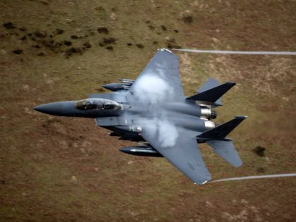 DOLGELLAU, WALES - FEBRUARY 16: A United States Air Force F-15 fighter jet based at RAF Lakenheath speeds through the Dinas Pass, known in the aviation world as the Mach Loop on February 16, 2018 in Dolgellau, Wales. United Kingdom. The Royal Air Force and aircraft of the United States …