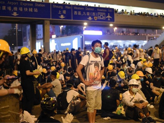 Demonstrators occupy a street the night after a protest against a controversial extradition law proposal in Hong Kong on June 12, 2019. - Violent clashes broke out in Hong Kong on June 12 as police tried to stop protesters storming the city's parliament, while tens of thousands of people blocked …