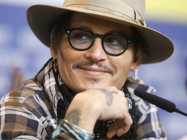 Actor Johnny Depp attends a news conference for the film Minamata during the 70th International Film Festival Berlin, Berlinale in Berlin, Germany, Friday, Feb. 21, 2020. (AP Photo/Markus Schreiber)