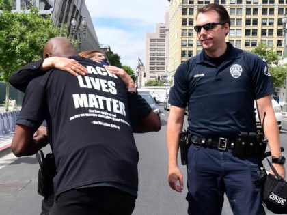 LAPD hug (Frederic J. Brown / AFP / Getty)