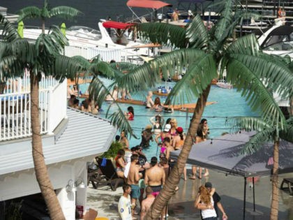 Crowds of people gather at Coconuts Caribbean Beach Bar & Grill in Gravois Mills, Missouri, Sunday, May 24, 2020. Several beach bars along Lake of the Ozarks were packed with party-goers during the Memorial Day weekend. Several political leaders in the St. Louis and Kansas City areas, as well as …