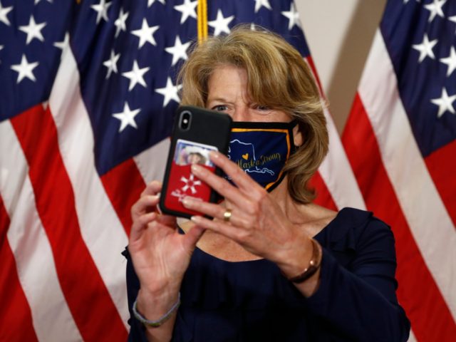 Sen. Lisa Murkowski, R-Alaska, takes a selfie as she wears an Alaska-themed face mask to protect against the spread of the new coronavirus before attending a weekly Republican Senate luncheon on Capitol Hill in Washington, Tuesday, May 19, 2020. (AP Photo/Patrick Semansky)