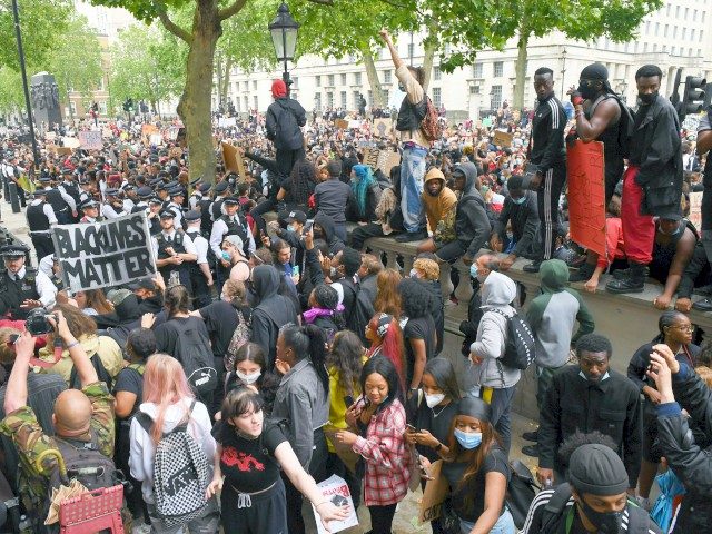 LONDON, ENGLAND - JUNE 03: Protesters are held back by police outside Downing Street durin