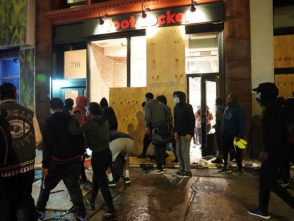 People loot a store during demonstrations over the death of George Floyd by a Minneapolis police officer on June 1, 2020 in New York. - New York's mayor Bill de Blasio today declared a city curfew from 11:00 pm to 5:00 am, as sometimes violent anti-racism protests roil communities nationwide. …