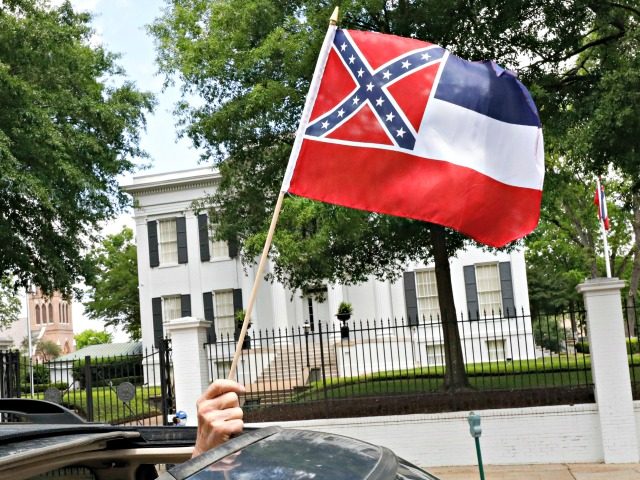 In this April 25, 2020 photograph, a small Mississippi state flag is held by a participant