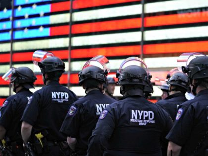 NYPD beside a flag