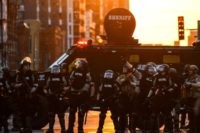 TOPSHOT - State patrol officers stand by a sheriff armored vehicule during a protest over the death of George Floyd on May 31, 2020 in Minneapolis, Minnesota. - Thousands of National Guard troops patrolled major US cities after five consecutive nights of protests over racism and police brutality that boiled …