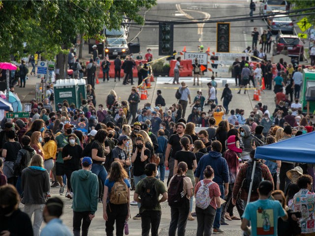 People walk near the Seattle Police Departments East Precinct in the so-called "Capitol Hi