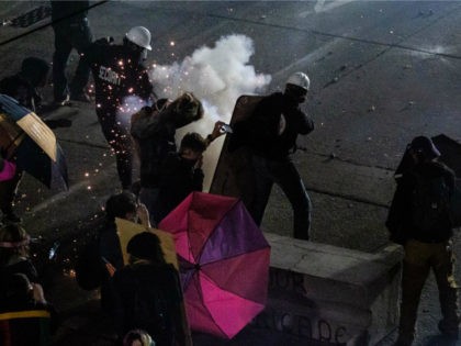 Demonstrators clash with law enforcement near the Seattle Police Departments East Precinct shortly after midnight on June 8, 2020 in Seattle, Washington. Earlier in the evening, a suspect drove into the crowd of protesters and shot one person, which happened after a day of peaceful protests across the city. Later, …