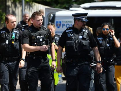 Police officers congregate outside a cordoned off block of flats where the suspect of a multiple stabbing incident lived in Reading, west of London, on June 23, 2020. - British counter-terrorism police have been given until June 27 to question a suspect widely identified as Libyan Khairi Saadallah in an …