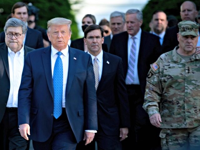 US President Donald Trump walks with US Attorney General William Barr (L), US Secretary of Defense Mark T. Esper (C), Chairman of the Joint Chiefs of Staff Mark A. Milley (R), and others from the White House to visit St. John's Church after the area was cleared of people protesting …