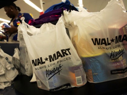 Shopping bags lie on a checkout counter of a Wal-Mart Supercenter May 11, 2005 in Troy, Ohio. Wal-Mart, America's largest retailer and the largest company in the world based on revenue, has evolved into a giant economic force for the U.S. economy. With growth, the company continues to weather criticism …