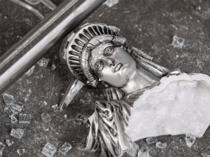 A broken Statue of Liberty figure is seen between glass shatters outside a looted souvenir shop after a night of protest over the death of an African-American man George Floyd in Minneapolis on June 2, 2020 in Manhattan in New York City