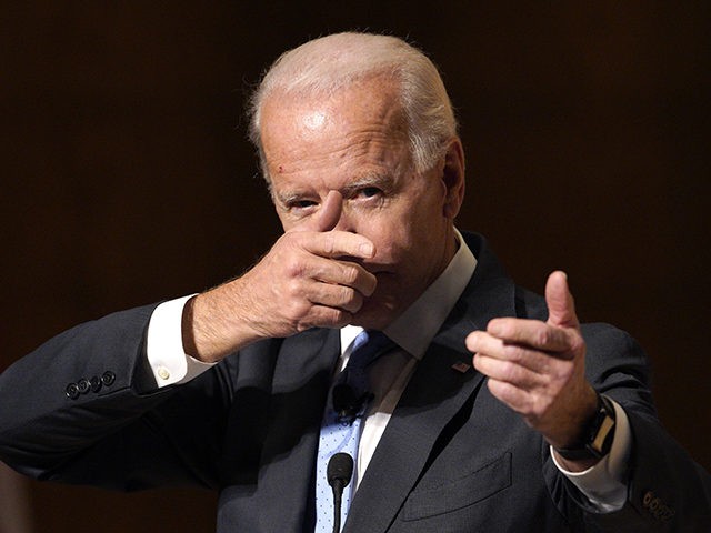 Former Vice President Joe Biden mimics shooting a gun as he speaks at the Chuck Hagel Foru