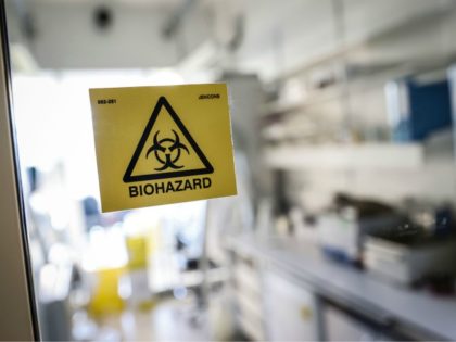 A picture taken in a laboratory of the National Reference Center (CNR) for respiratory viruses at the Institut Pasteur in Paris on January 28, 2020 shows a biohazard sticker on the entrance of a room. - The CNR analyses the tests for respiratory viruses among which coronavirus. The deadly new …