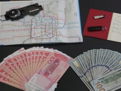 The article said a compass, a USB stick, a notebook, a map of Shanghai and cash were among several items seized in the operation.(Global Times)