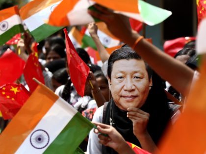 FILE- In this Oct. 10, 2019 file photo, an Indian schoolgirl wears a face mask of Chinese President Xi Jinping to welcome him on the eve of his visit in Chennai, India. Tensions along the China-India border high in the Himalayas have flared again in recent weeks. Â Indian officials …