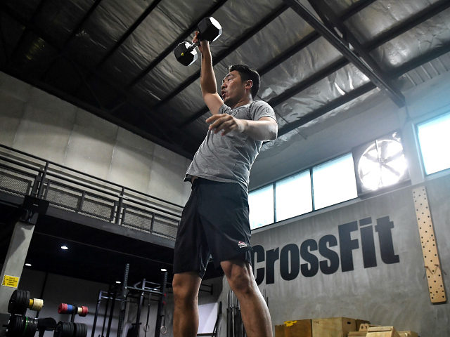 A gym enthusiast exercised whilst maintaining distance from others at CrossFit Arena Bangkok, during their first week of reopening following closure of physical wellness centers after authorities lifted some measures of restrictions to halt the spread of the COVID-19 coronavirus in Bangkok on May 20, 2020. (Photo by Lillian SUWANRUMPHA …