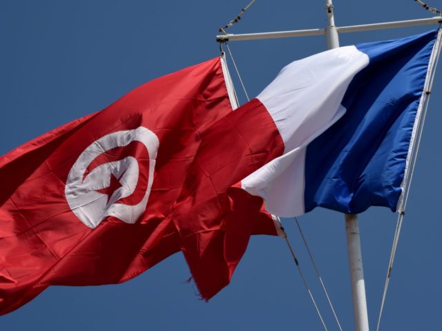 French and Tunisian flags float during a ceremony to mark the 71th anniversary of the end