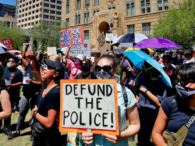 Protesters rally Wednesday, June 3, 2020, in Phoenix, demanding that the Phoenix City Council defund the Phoenix Police Department. The protest is a result of the death of George Floyd, a black man who died after being restrained by Minneapolis police officers on May 25. (AP Photo/Matt York) defund the …
