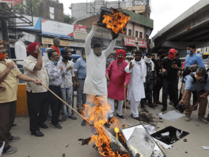 Indians burn products made in China during a protest against the Chinese government in Luc