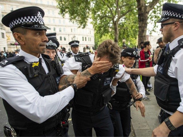 LONDON, ENGLAND - JUNE 03: An injured police officer, who appeared to have been struck in the head by a thrown object, is assisted by his colleagues during a Black Lives Matter protest at Trafalgar Square June 03, 2020 in London, England. The death of an African-American man, George Floyd, …