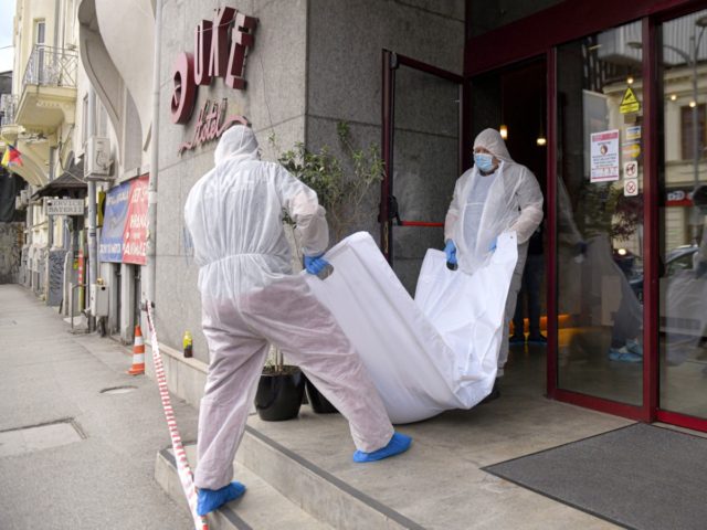 Forensic workers carry the body of Gholamreza Mansouri from a hotel downtown Bucharest, Ro