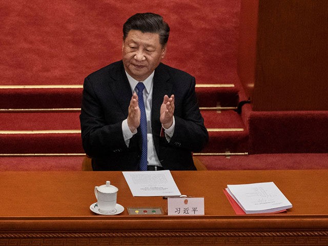BEIJING, CHINA - MAY 28: Chinese president Xi Jinping, applauds the results of a vote on a new draft security bill for Hong Kong during the closing session of the National People's Congress at the Great Hall of the People on May 28, 2020 in Beijing, China. The Chinese government …