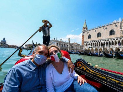 People enjoy a gondola ride past the Doge's Palace on May 29, 2020 in Venice, as the country eases its lockdown aimed at curbing the spread of the COVID-19 infection, caused by the novel coronavirus. (Photo by ANDREA PATTARO / AFP) (Photo by ANDREA PATTARO/AFP via Getty Images)