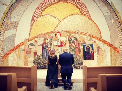 President Donald Trump and First Lady Melania Trump knelt in prayer behind the scenes during their visit to the Saint John Paul II National Shrine in Washington, DC, on Tuesday.