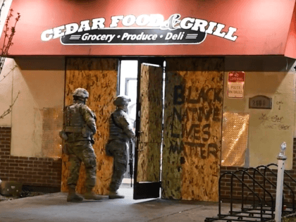 Soldiers with the Minnesota National Guard's 2nd Battalion, 136th Infantry Regiment of the 1st Armored Brigade Combat Team, 34th Red Bull Infantry Division, protect a corner store in Minneapolis.