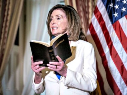 House Speaker Nancy Pelosi speaks while holding a bible during an event at the U.S. Capito