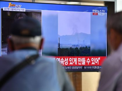People watch a television news screen showing smoke from the explosion of an inter-Korean liaison office in North Korea's Kaesong Industrial Complex, at a railway station in Seoul on June 16, 2020. - North Korea blew up an inter-Korean liaison office on its side of the border on June 16, …