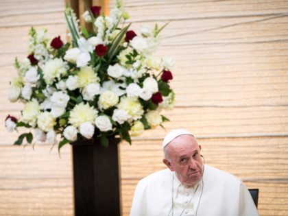 Pope Francis listens to the speech of Japan's Prime Minister Shinzo Abe as they attend a meeting with the diplomatic community at the prime minister's office in Tokyo on November 25, 2019. - Pope Francis called on November 25 for renewed efforts to help victims of Japan's 2011 "triple disaster" …