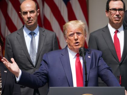 US President Donald Trump, with US Secretary of the Treasury Steven Mnuchin (R), holds a press conference on the economy, in the Rose Garden of the White House in Washington, DC, on June 5, 2020. - The US economy regained 2.5 million jobs in May as coronavirus pandemic shutdowns began …