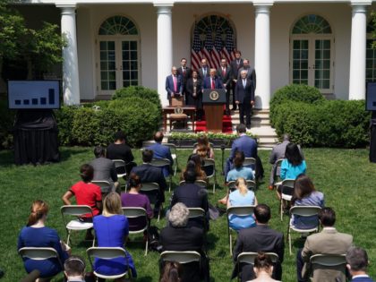 US President Donald Trump, with Director of the National Economic Council Larry Kudlow (L), holds a press conference on the economy, in the Rose Garden of the White House in Washington, DC, on June 5, 2020. - The US economy regained 2.5 million jobs in May as coronavirus pandemic shutdowns …