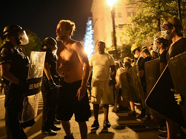 Protesters confront police officers during demonstrations at Lafayette square, in front of the White House, in Washington, DC on June 22, 2020, where earlier protesters tried to bring down the equestrian statue of former US President General Andrew Jackson. - A crowd of protestors tried to topple the statue of …