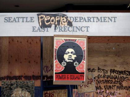 A 1970's-era poster of activist Angela Davis hangs at a boarded up and closed Seattle police precinct Sunday, June 21, 2020, in Seattle, where streets are blocked off in what has been named the Capitol Hill Occupied Protest zone. Police pulled back from several blocks of the city's Capitol Hill …