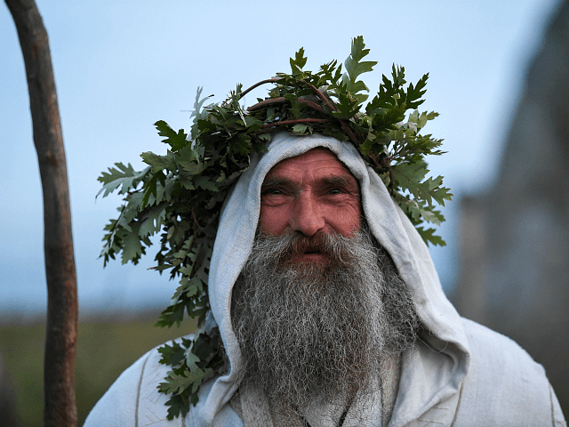WILTSHIRE, ENGLAND - JUNE 20: A druid named Merlin is seen at Stonehenge as the sun sets ahead of Summer Solstice on June 20, 2020 in Amesbury, United Kingdom. English Heritage, which manages the site, said 'Our priority is always to ensure the safety and wellbeing of staff, volunteers, attendees …