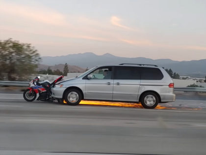 A suspected hit-and-run driver sped down a freeway with a motorcycle wrapped around his front bumper in Corona, California, on Friday.